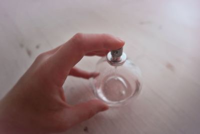 Close-up of hand holding glass of water