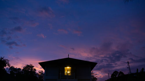 Low angle view of silhouette building against sky at sunset