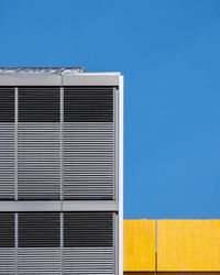 Low angle view of building against clear blue sky