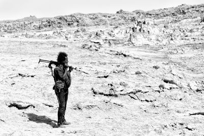 Rear view of man walking on beach