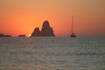 Scenic view of sea against orange sky