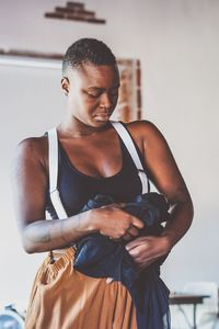 Woman holding cloth at home