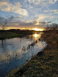 Scenic view of lake against sky during sunset