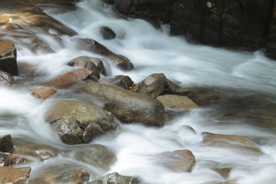 High angle view of river flowing through rocks