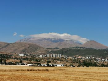 Scenic view of landscape and mountains against sky