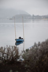 Sailboat in lake against sky