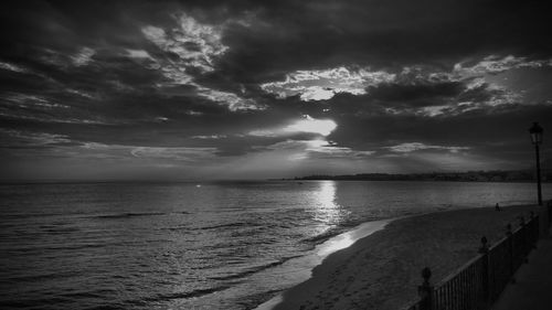 Scenic view of sea against storm clouds