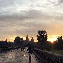 People walking in town square during sunset