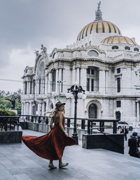 A young woman wearing a red dress in the streets of mexico city.