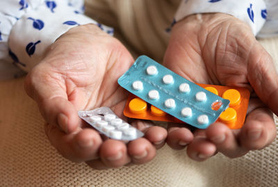 Cropped hands of woman holding medicine