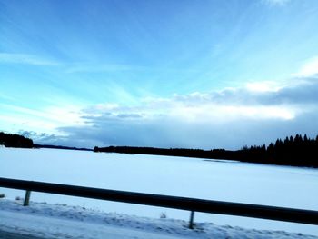 Scenic view of lake against sky during winter