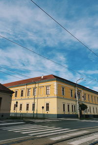 Road by building against sky