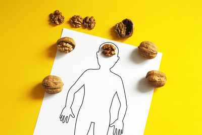 High angle view of bread on table against yellow background