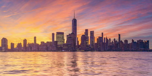 View of buildings in city at sunset