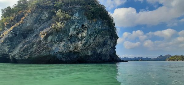 Scenic view of rock formation in sea against sky