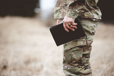 Midsection of man standing on field