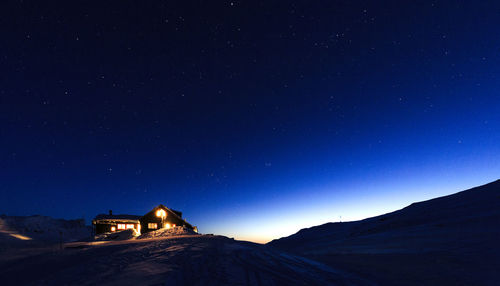 Scenic view of illuminated mountain against sky at night