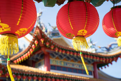 Low angle view of lanterns hanging against sky at night