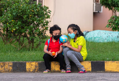 Guiding younger about using man made globe