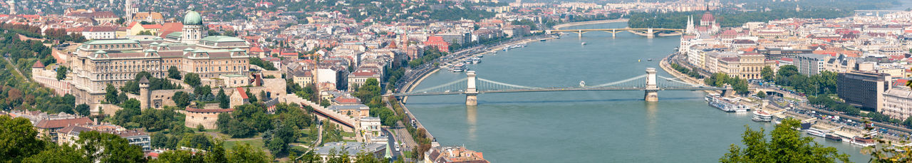 High angle view of bridge over river amidst buildings in city