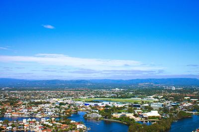 High angle view of cityscape against blue sky