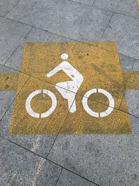 High angle view of bicycle lane sign on road