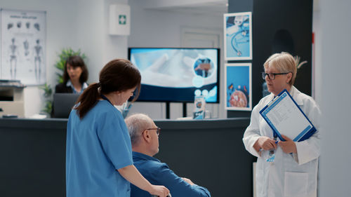 Doctor talking with patient at hospital