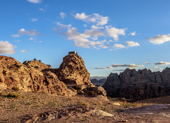 Rock formations on landscape against sky