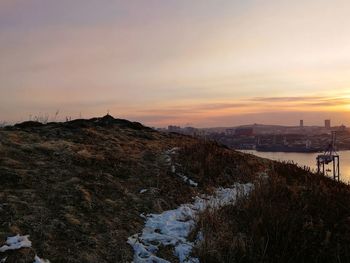 Scenic view of snow against sky during sunset