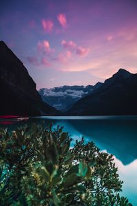Scenic view of lake and mountains against sky