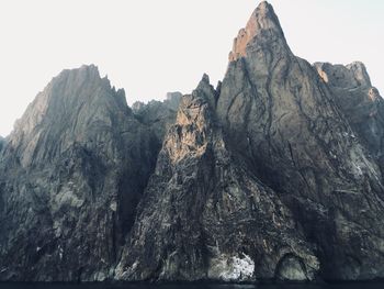 Panoramic view of rocky mountains against clear sky