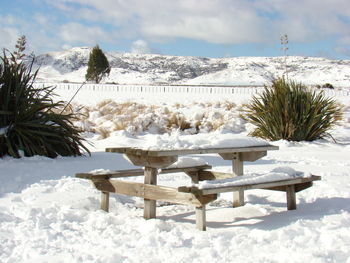 Built structure on snow covered land against sky