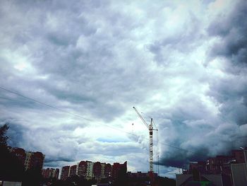 Low angle view of buildings against cloudy sky