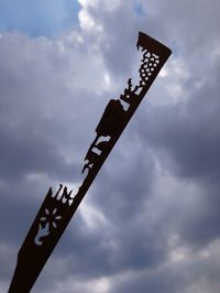 Low angle view of sign board against sky