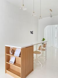 Empty chairs and table against wall at home