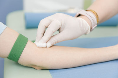 Cropped hands of doctor applying antiseptic to patient