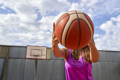 Young latina basketball player in open stadium