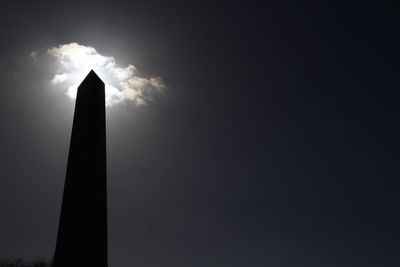 Low angle view of silhouette built structure against sky