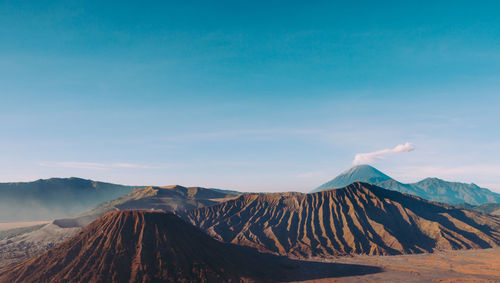 View of volcanic mountain against blue sky