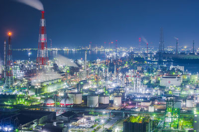 Illuminated cityscape against sky at night