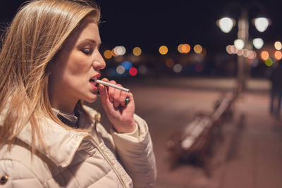 Portrait of woman looking away at night