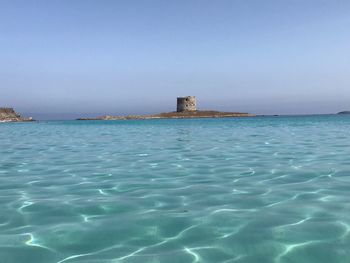 Scenic view of sea against clear blue sky