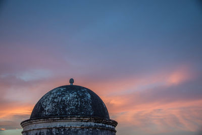 Historic building against sky during sunset