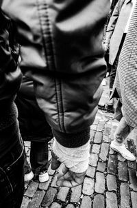 Low section of man standing on footpath