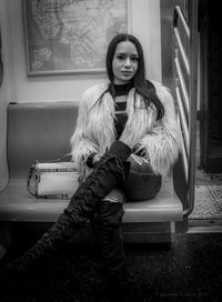 Portrait of young woman standing at home