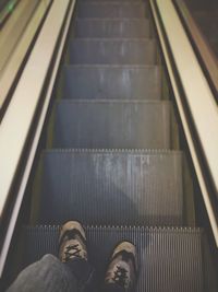 Low section of man standing on staircase
