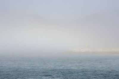 Scenic view of sea against sky during foggy weather