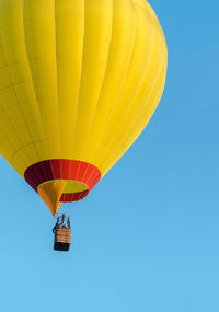 Low angle view of hot air balloon against blue sky