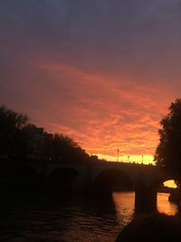 Bridge over river at sunset