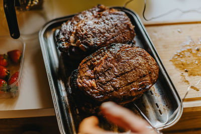 High angle view of meat in cooking pan on table